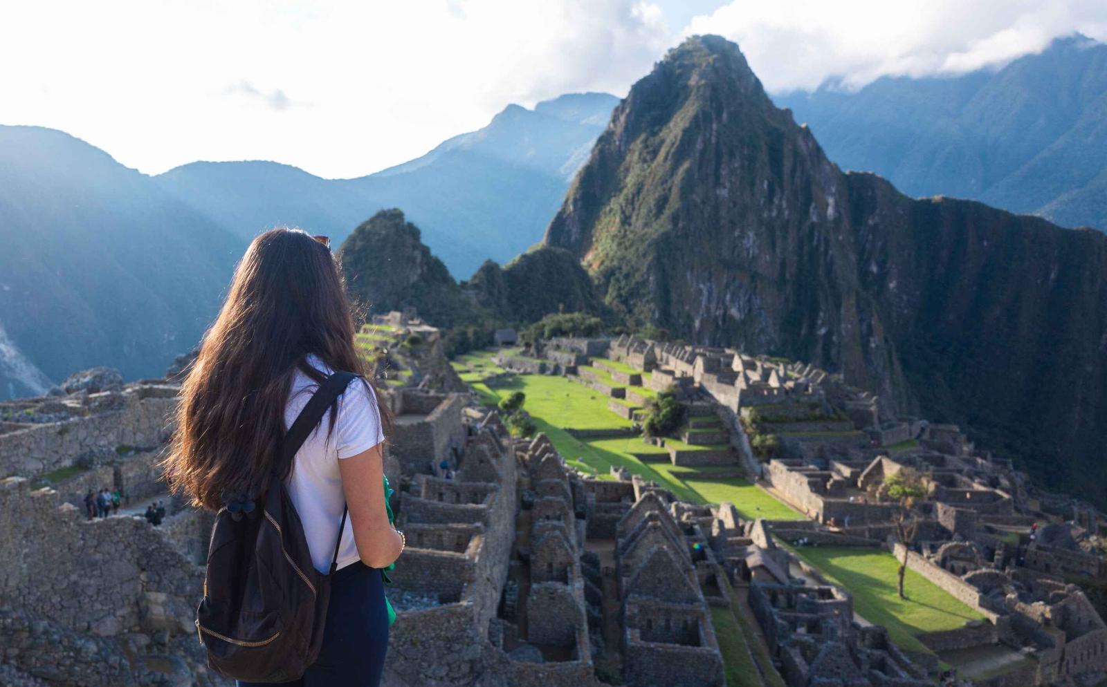 Volunteers in South America taking a photo of Machu Picchu while on a weekend break from their project in Peru.